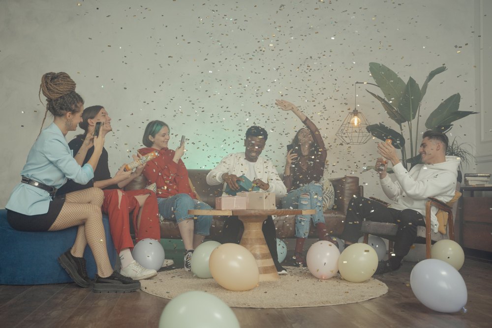 Friends celebrating together with balloons and confetti